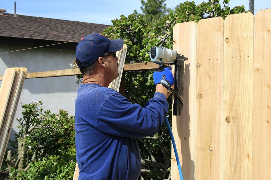 Fence posts wood building build diy straight line post concrete setting set tools while hold plumb installing keep myfixituplife use